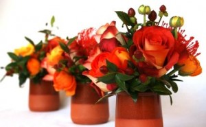 Leucospermum, orange roses and berry arrangmnet